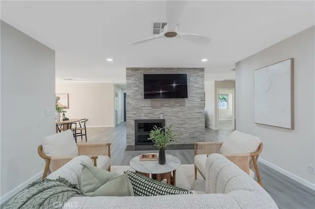 a living room with furniture and a fireplace