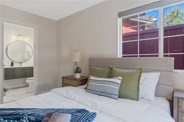 a bedroom with a large bed and a window