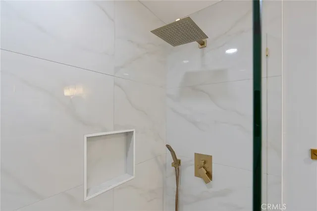 a bathroom with a shower and a mirror