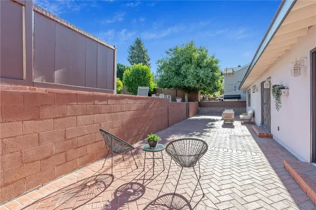 a view of a chairs and table in patio