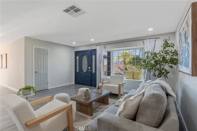 a living room with furniture and a potted plant