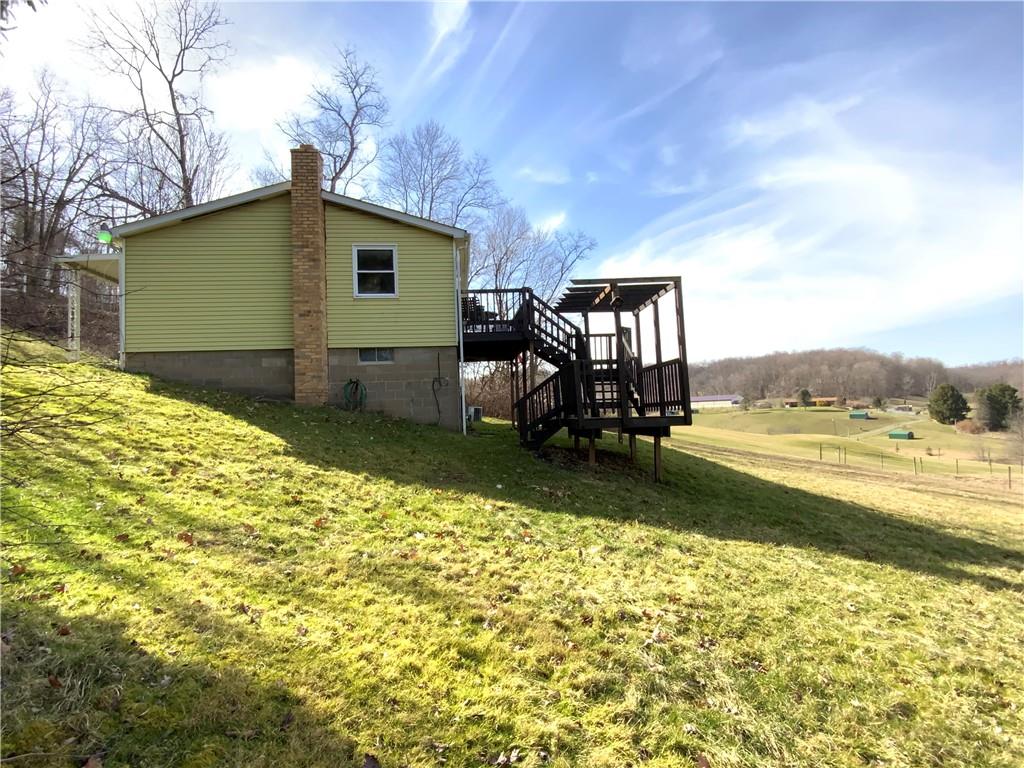229 Upper Service Road Hookstown, PA 15050 - Photo 2 of 21 a backyard of a house with table and chairs
