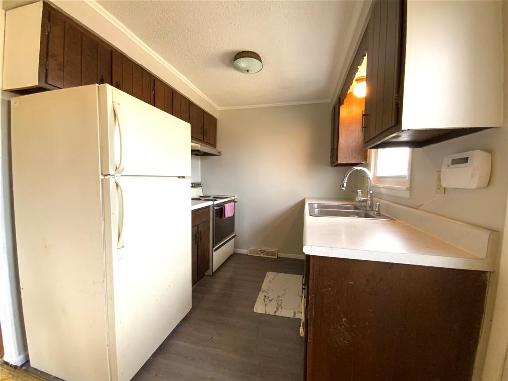 229 Upper Service Road Hookstown, PA 15050 - Photo 6 of 21 a kitchen with a sink a refrigerator and a stove