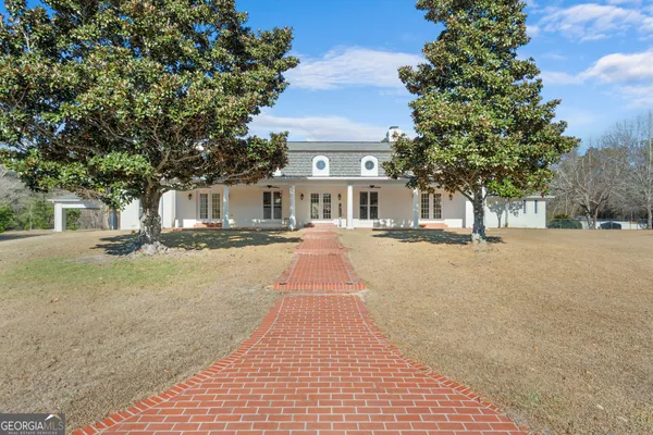 a front view of a building with trees