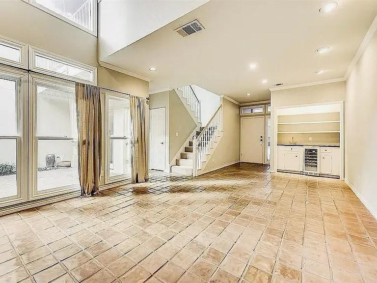 4518 Glenwick Lane Dallas, TX 75205 - Photo 12 of 14 a view of a hallway with a glass door and chandelier