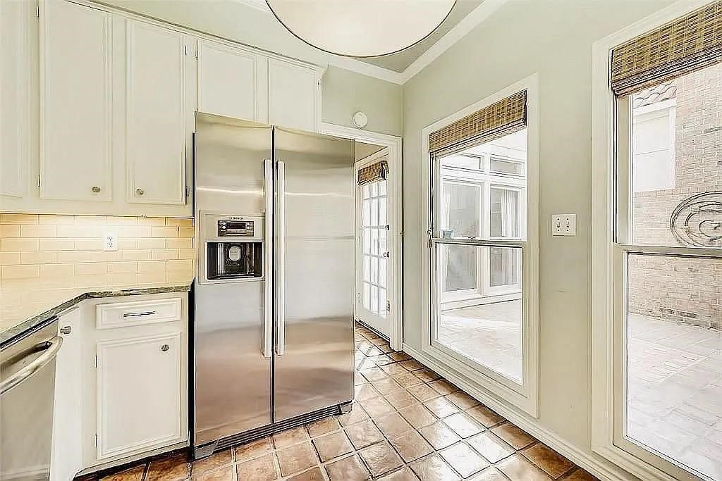 4518 Glenwick Lane Dallas, TX 75205 - Photo 3 of 14 a kitchen with white cabinets and glass door