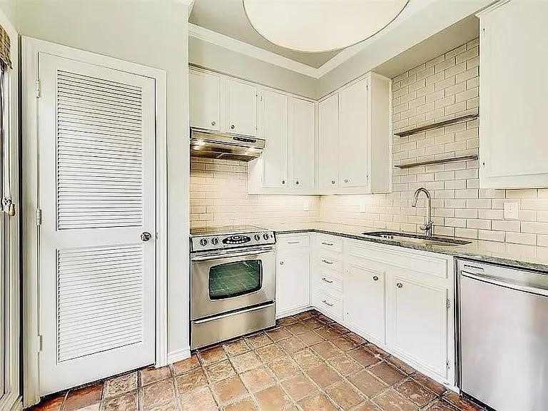 4518 Glenwick Lane Dallas, TX 75205 - Photo 7 of 14 a kitchen with granite countertop white cabinets stainless steel appliances and a sink