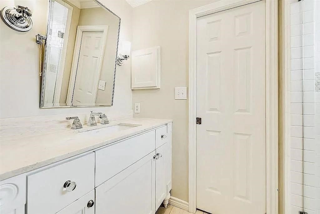 4518 Glenwick Lane Dallas, TX 75205 - Photo 9 of 14 a bathroom with a sink and a mirror