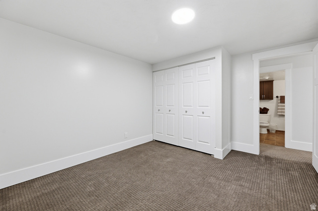 2342 Charros Road Sandy, UT 84092 - Photo 58 of 94 Spacious room featuring neutral carpeting, white baseboards, and a large bi-fold closet with panel doors