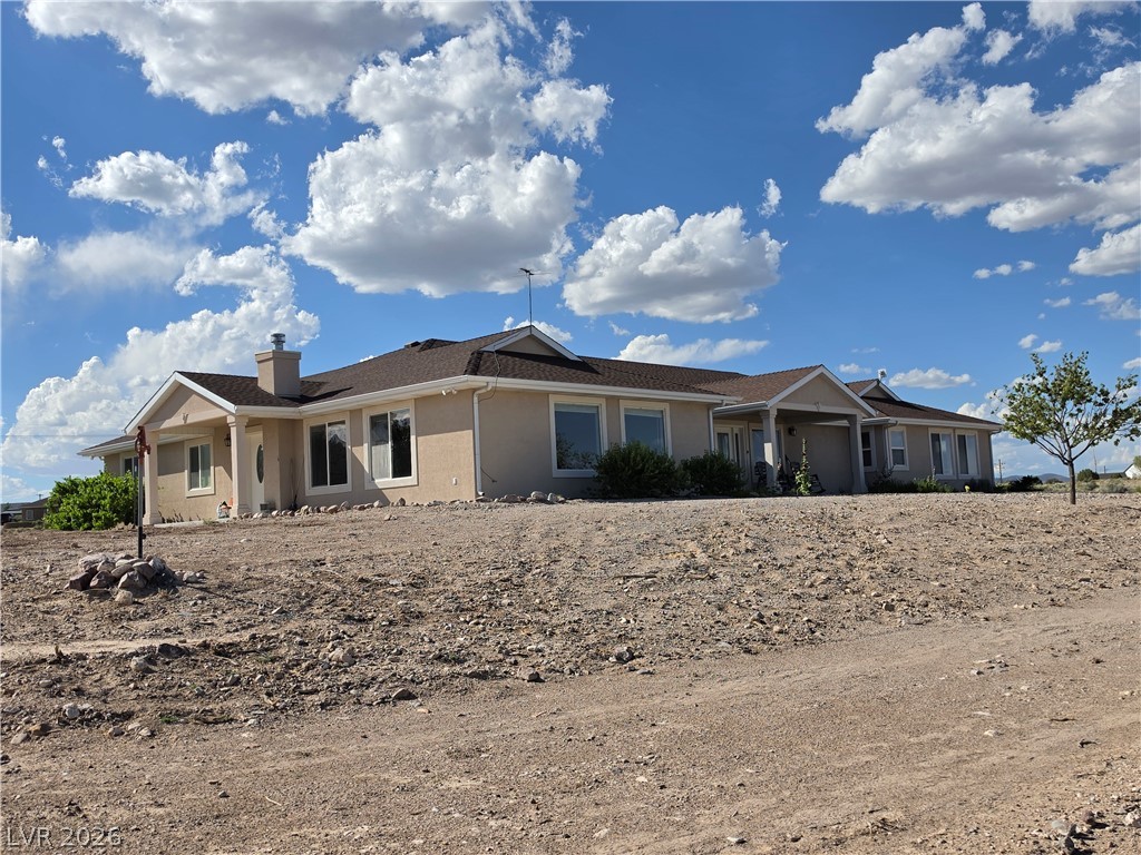 5272 Truman Lane Caliente, NV 89008 - Photo 38 of 43 A sprawling stucco residence with a classic gabled roof and ample windows.