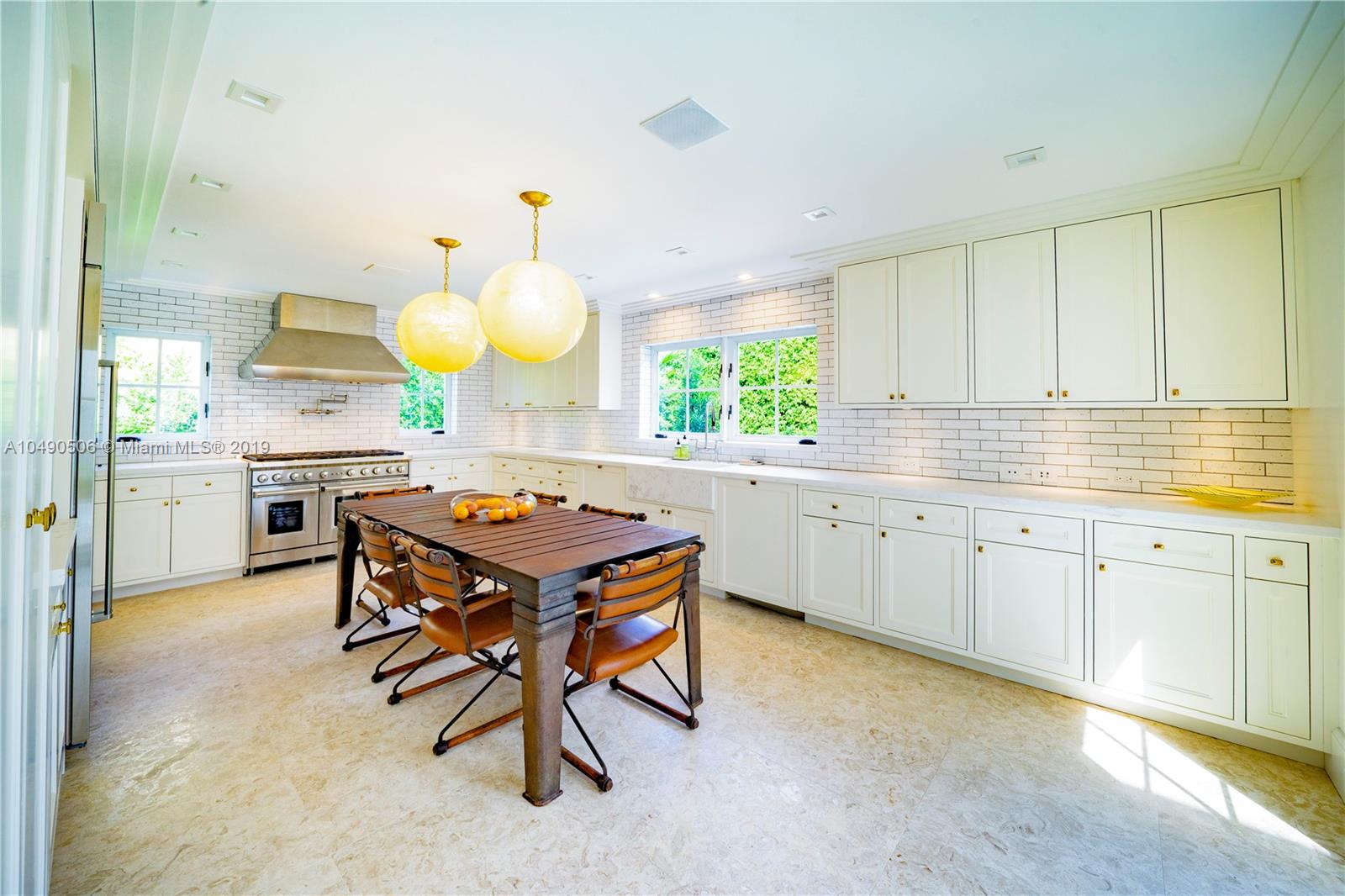 6332 Alton Road Miami Beach, FL 33141 - Photo 18 of 91 a kitchen with a table and chairs in it