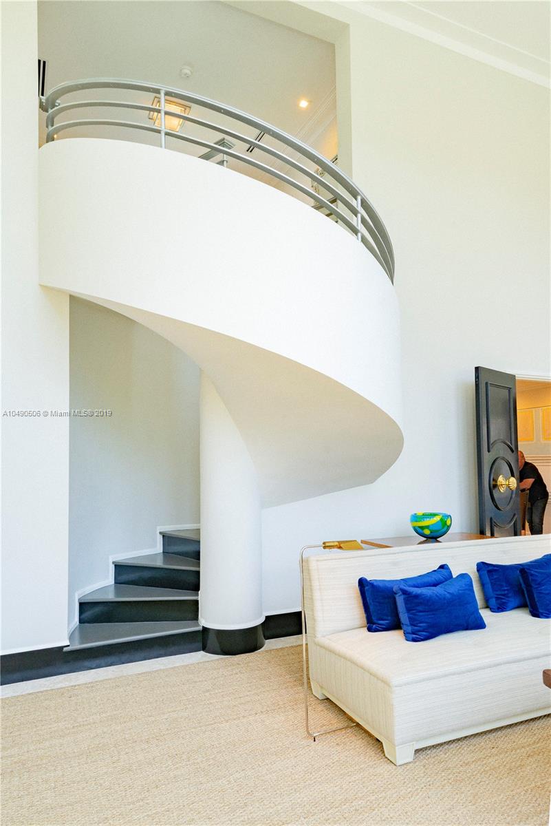 6332 Alton Road Miami Beach, FL 33141 - Photo 22 of 91 a living room with furniture and a chandelier