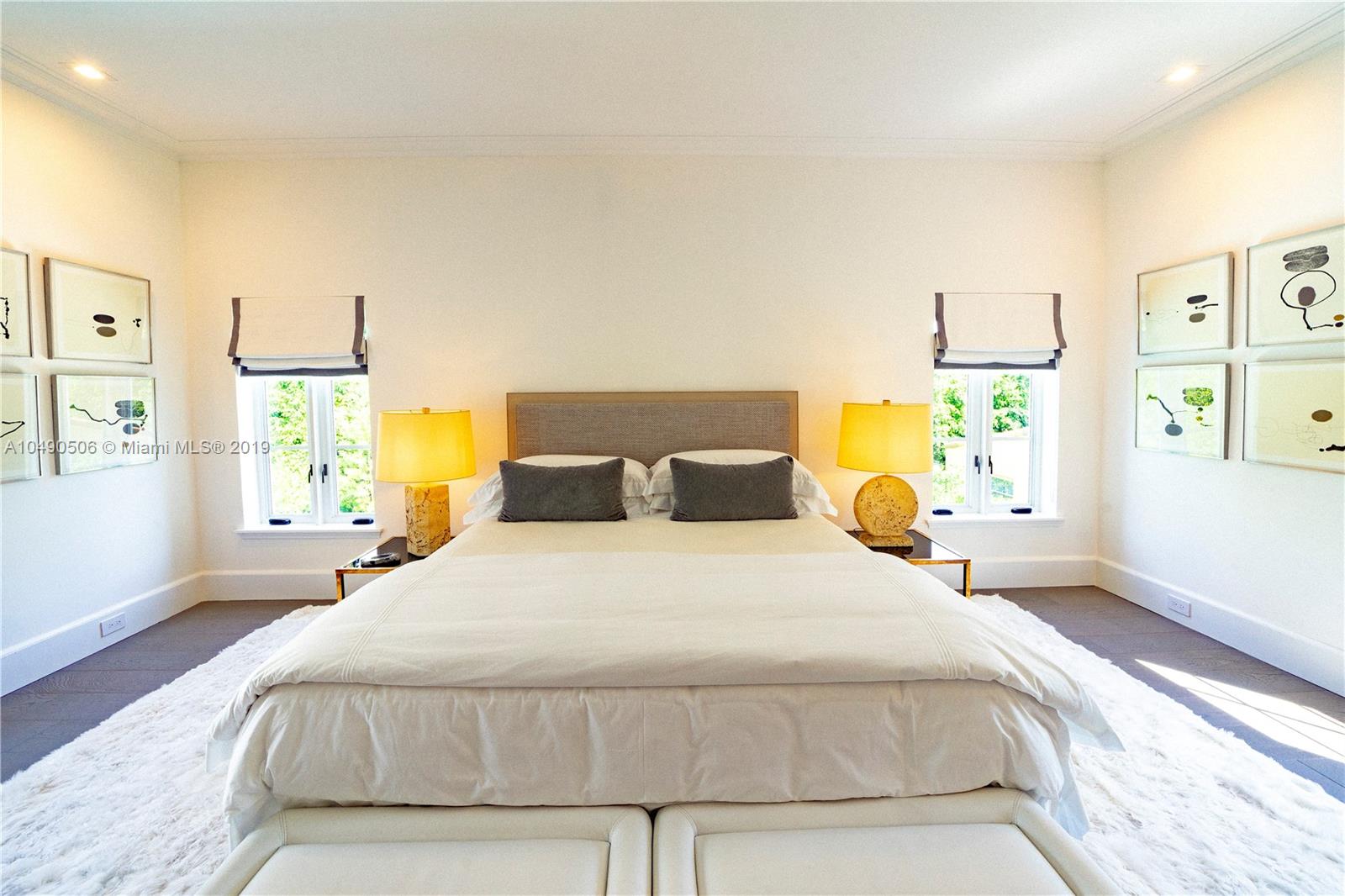 6332 Alton Road Miami Beach, FL 33141 - Photo 26 of 91 a bedroom with a bed and wooden floor