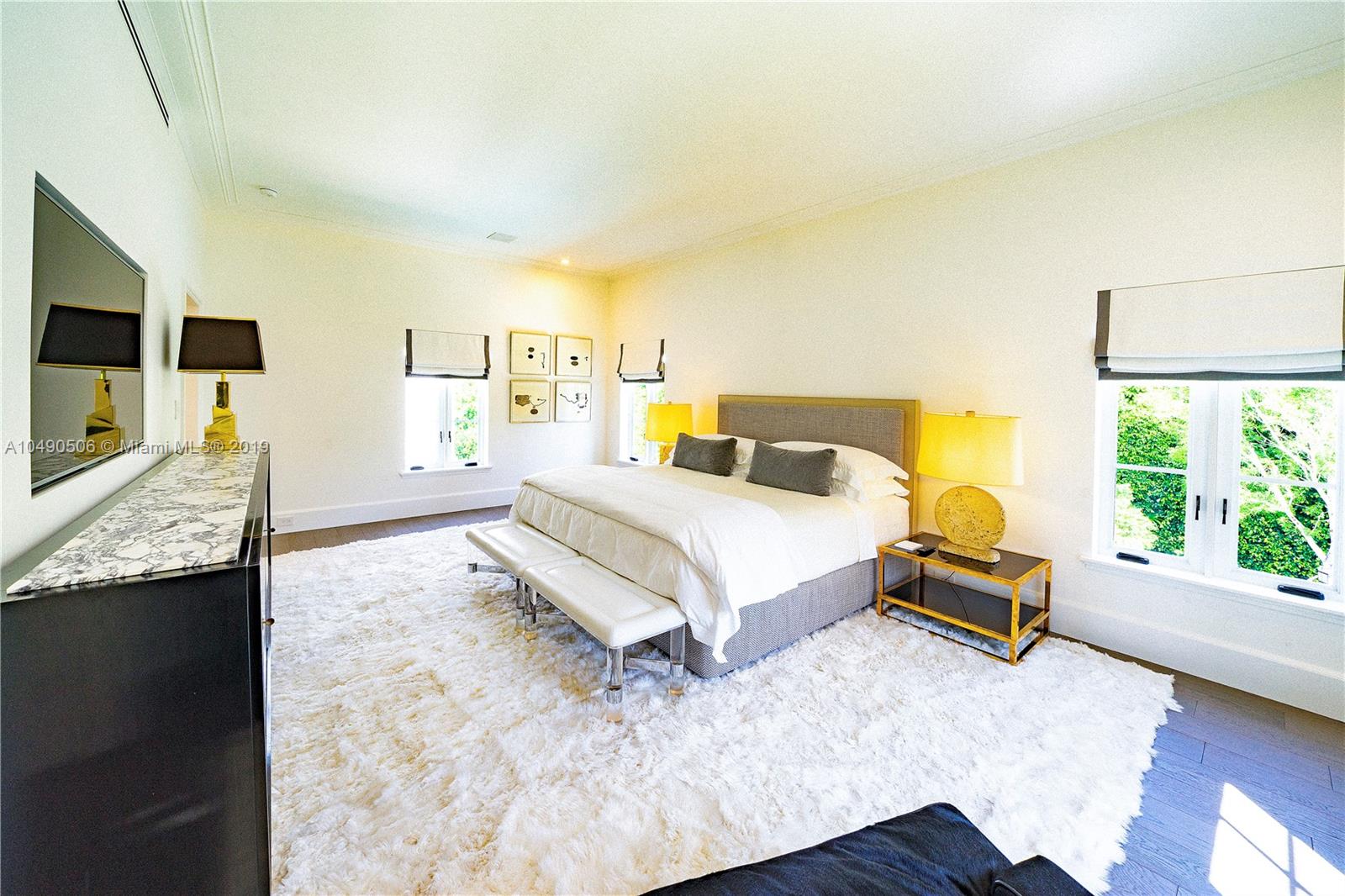 6332 Alton Road Miami Beach, FL 33141 - Photo 28 of 91 a bedroom with a bed and flat screen tv