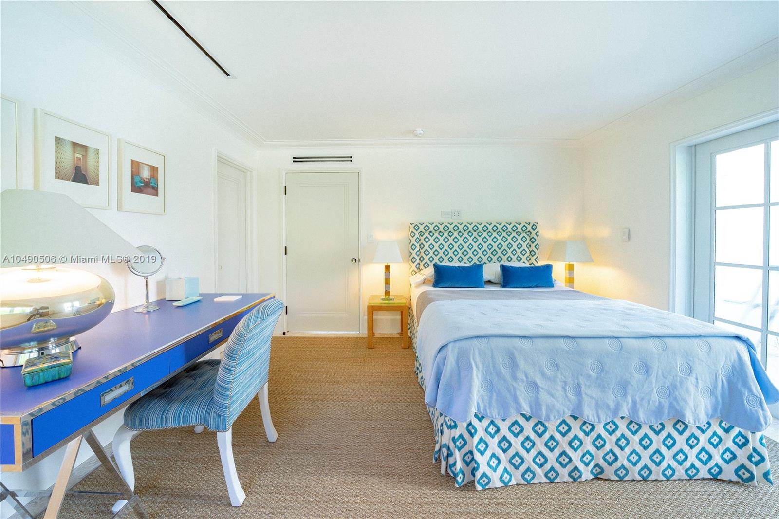 6332 Alton Road Miami Beach, FL 33141 - Photo 43 of 91 a bedroom with a bed and a table in it