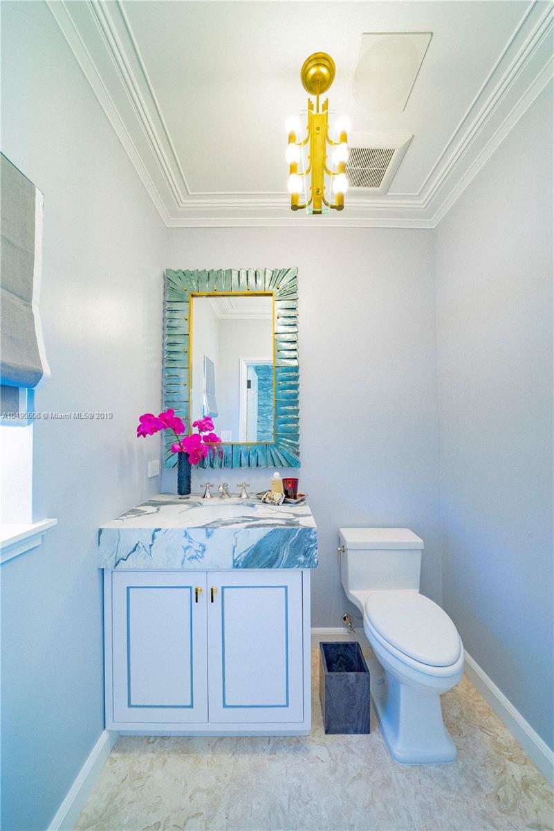 6332 Alton Road Miami Beach, FL 33141 - Photo 55 of 91 a bathroom with a sink and a mirror