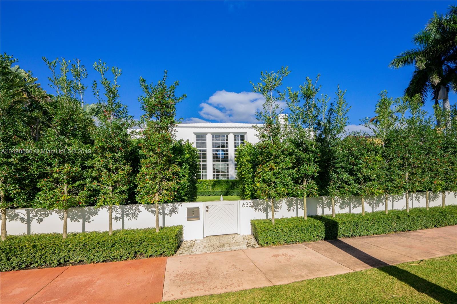 6332 Alton Road Miami Beach, FL 33141 - Photo 77 of 91 a front view of a house with a yard and tree s