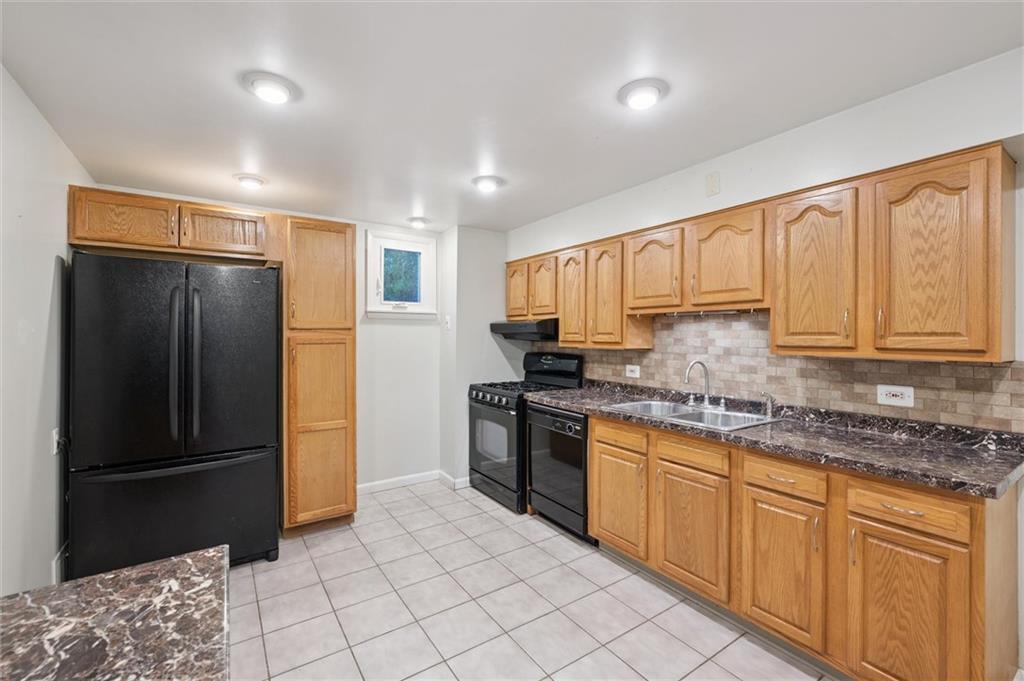 677 Greentree Road Pittsburgh, PA 15220 - Photo 11 of 29 a kitchen with stainless steel appliances granite countertop a refrigerator sink and cabinets