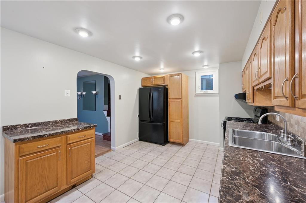 677 Greentree Road Pittsburgh, PA 15220 - Photo 13 of 29 a kitchen with granite countertop a refrigerator stove and sink