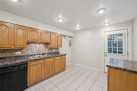 a kitchen with stainless steel appliances granite countertop a sink and cabinets