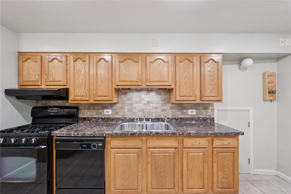 677 Greentree Road Pittsburgh, PA 15220 - Photo 15 of 29 a kitchen with granite countertop a sink stove and cabinets