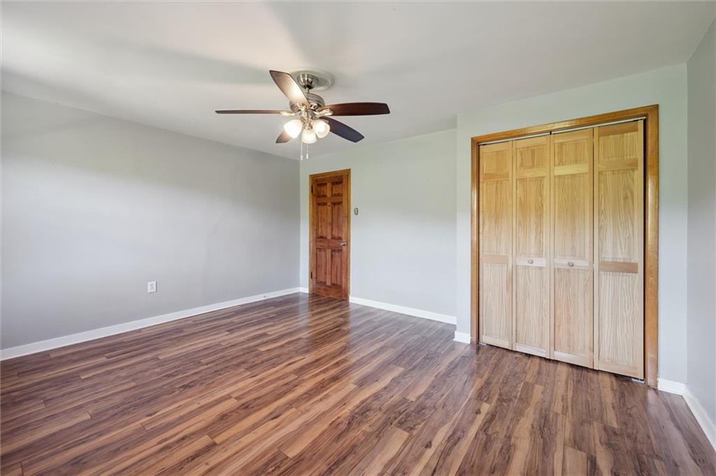 677 Greentree Road Pittsburgh, PA 15220 - Photo 17 of 29 an empty room with wooden floor closet and fan