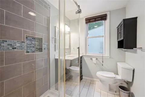 a bathroom with a toilet a sink and bathtub