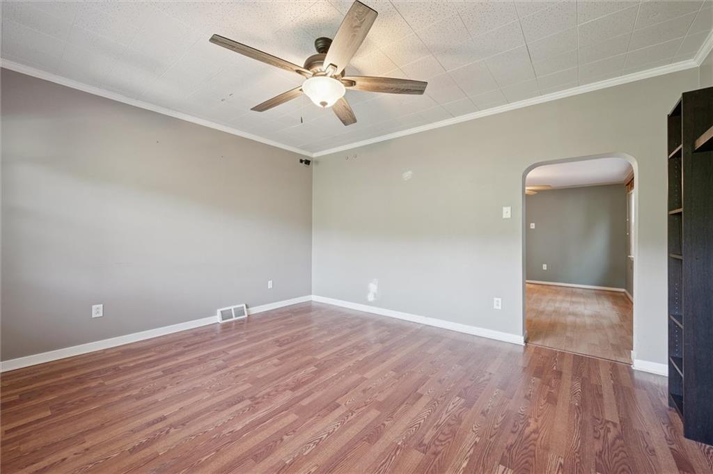 677 Greentree Road Pittsburgh, PA 15220 - Photo 8 of 29 an empty room with wooden floor and fan