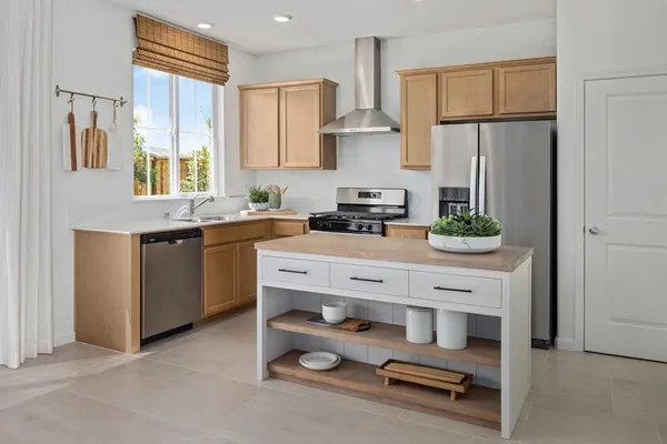 a kitchen with stainless steel appliances a sink stove and refrigerator