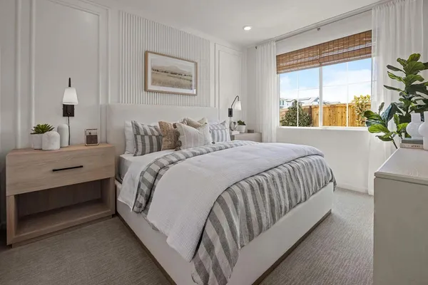 a bedroom with a large bed and a window
