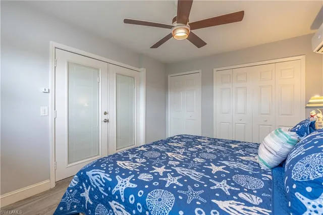 a bedroom with a large bed and a chandelier