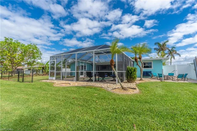 a view of a lake with a bench and trees around