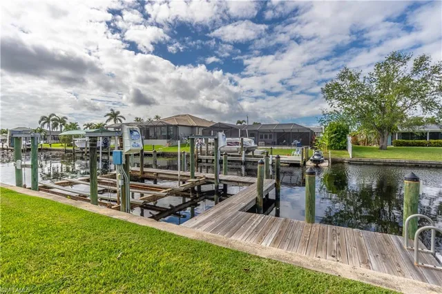 a view of a terrace with lawn chairs