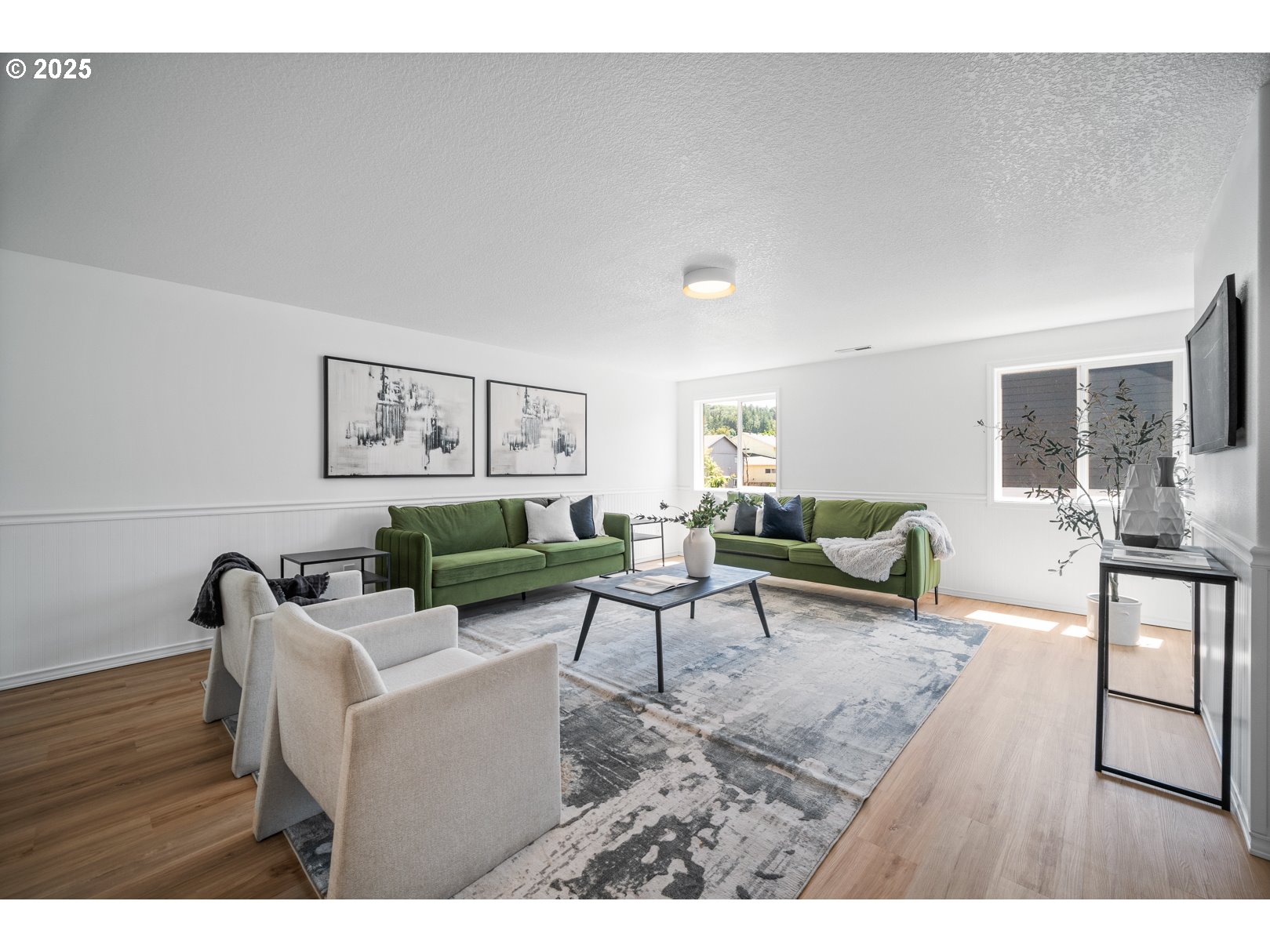 2952 Northwest Ogden Street Camas, WA 98607 - Photo 20 of 31 a living room with furniture a wooden floor and a flat screen tv