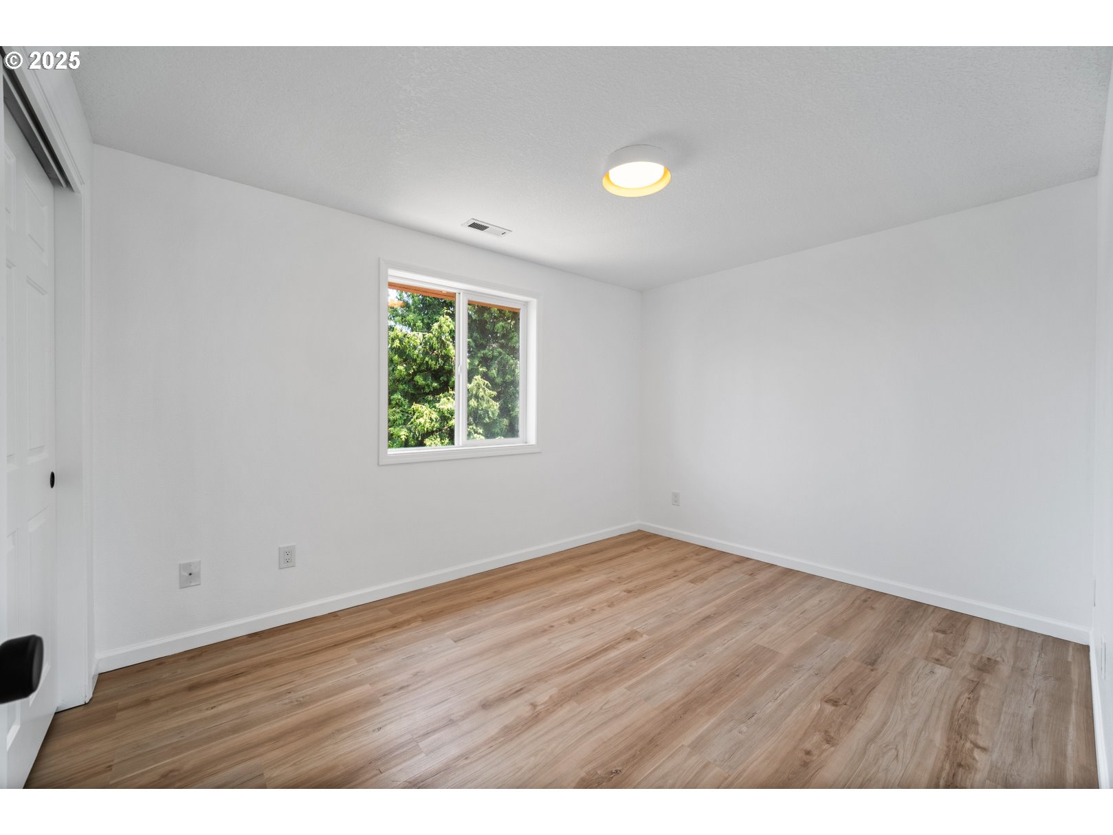 2952 Northwest Ogden Street Camas, WA 98607 - Photo 24 of 31 an empty room with wooden floor and windows