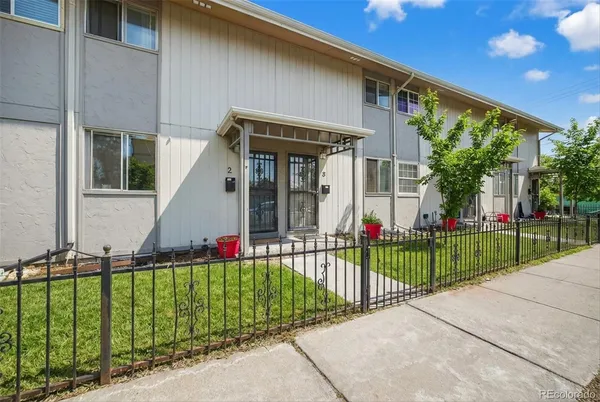 a view of a house with a small yard and plants
