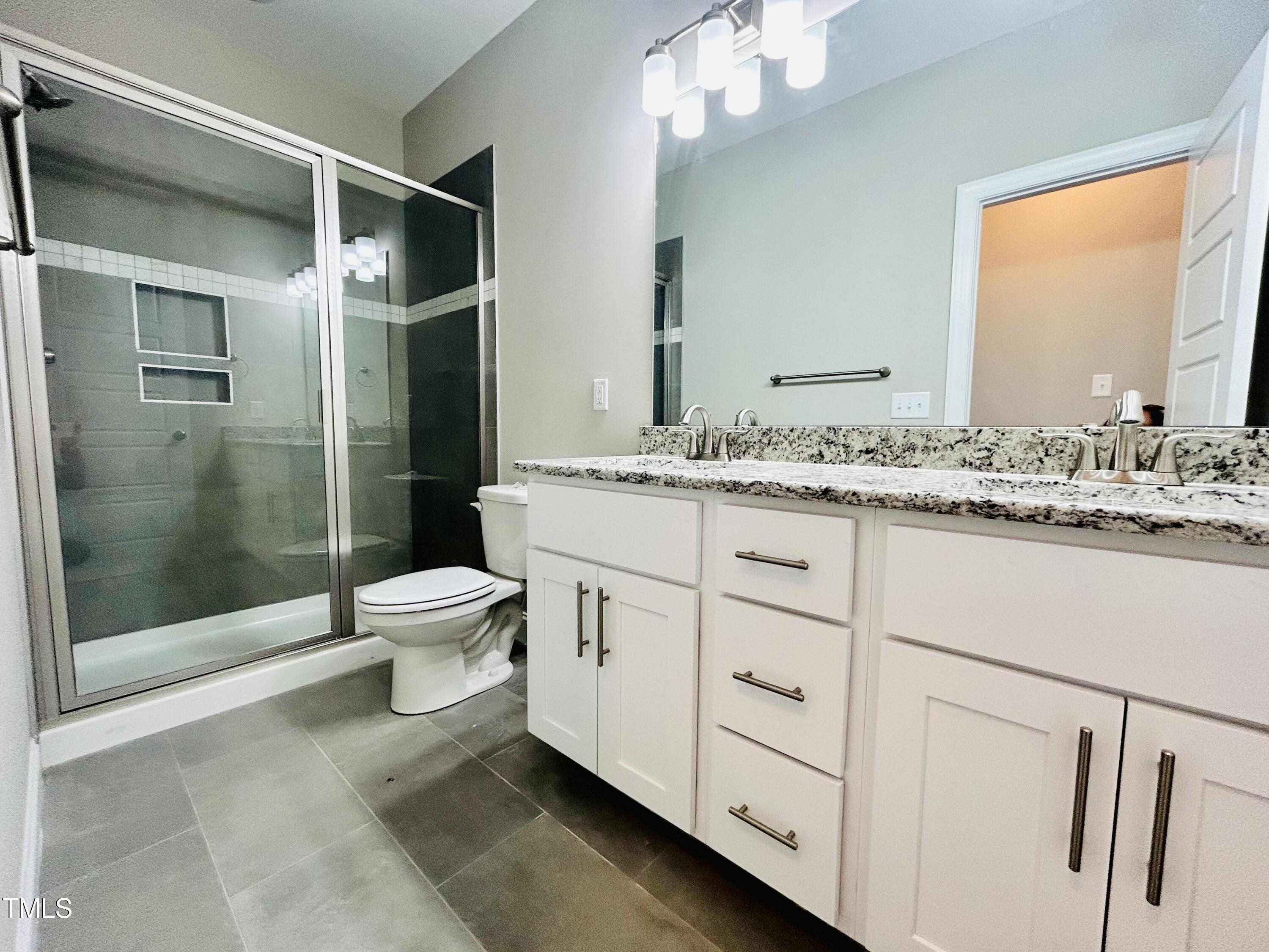 9787 Pace Road Bailey, NC 27807 - Photo 11 of 18 a bathroom with a granite countertop sink toilet and shower