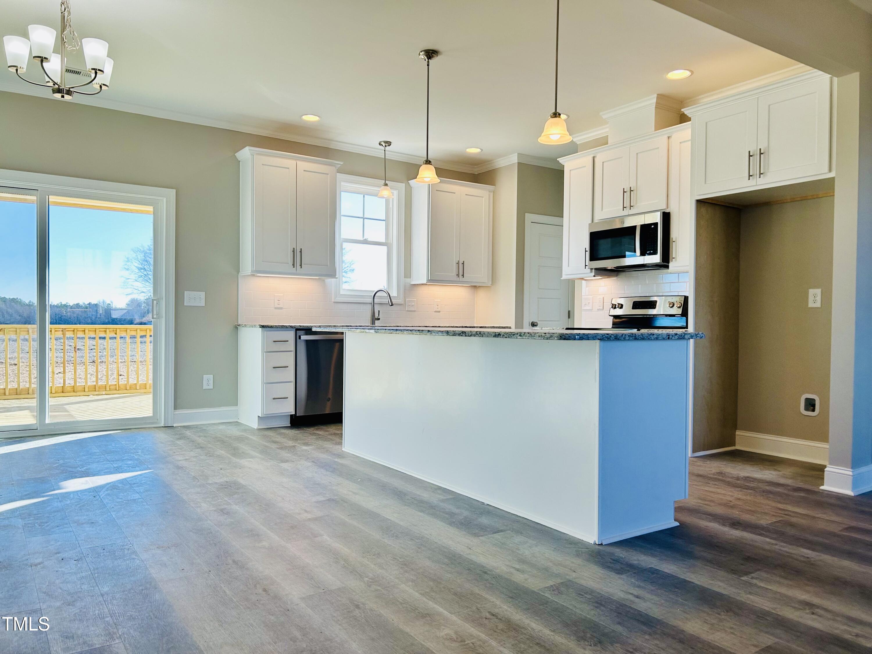 9787 Pace Road Bailey, NC 27807 - Photo 4 of 18 a kitchen with kitchen island granite countertop a stove and a sink