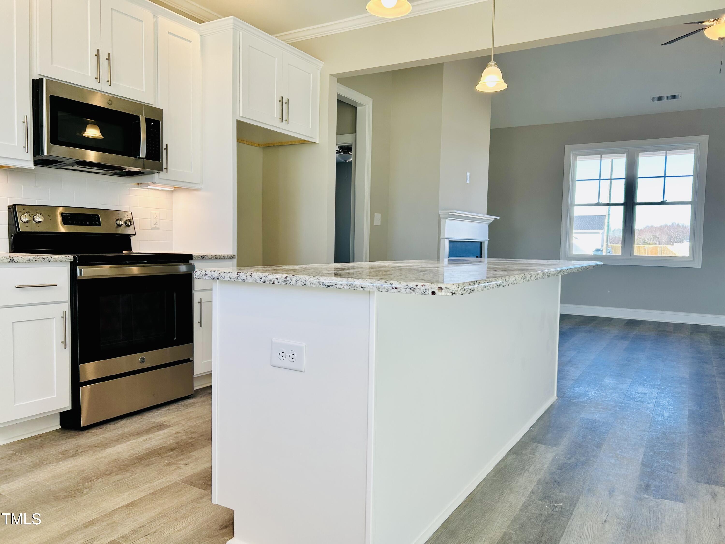 9787 Pace Road Bailey, NC 27807 - Photo 5 of 18 a kitchen with stainless steel appliances granite countertop a refrigerator stove a sink and a microwave