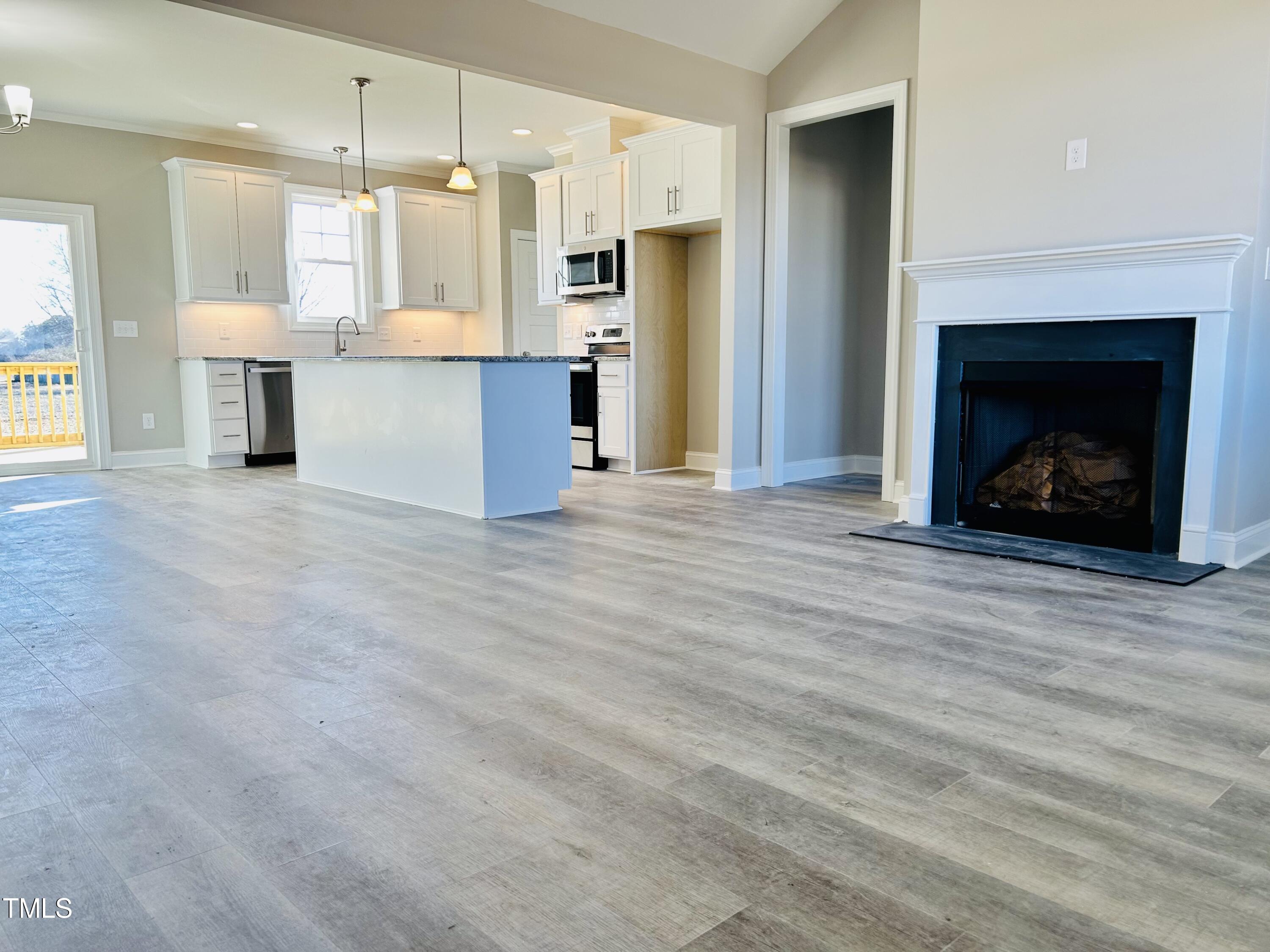 9787 Pace Road Bailey, NC 27807 - Photo 7 of 18 a view of a kitchen with a sink and a fireplace