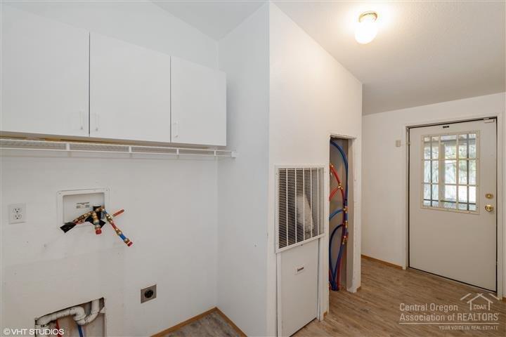 53435 Deep Woods Road La Pine, OR 97739 - Photo 14 of 19 Laundry room has extra cabinet storage s