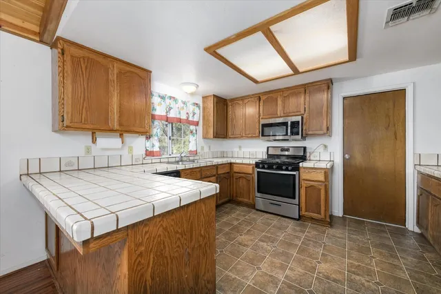 a kitchen with a stove a sink and a microwave