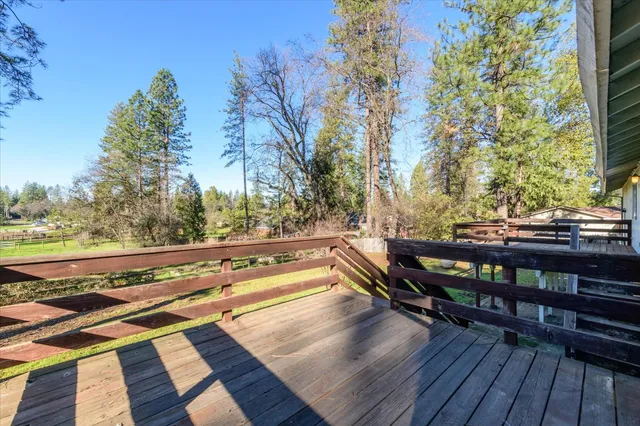 a view of a roof deck with wooden floor and city view