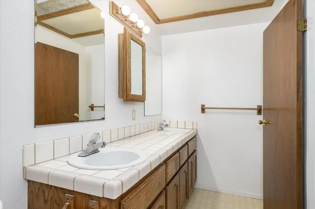 a bathroom with a sink and a mirror
