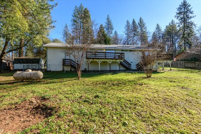 a view of a house with backyard and sitting area
