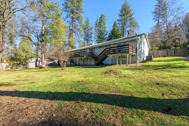 a view of a house with yard and lake view