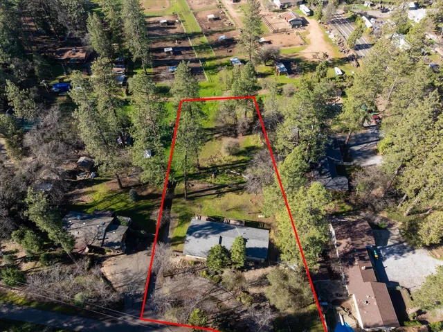 an aerial view of a houses with a yard