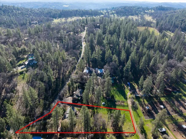 an aerial view of residential house with green space