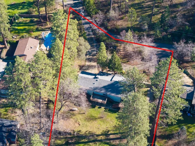 an aerial view of a house with a yard