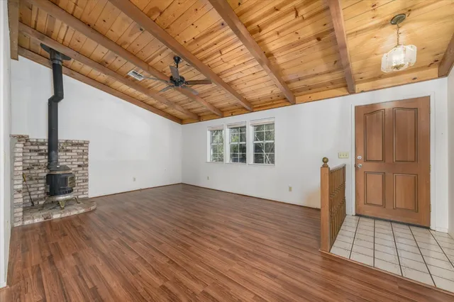 an empty room with wooden floor and white walls